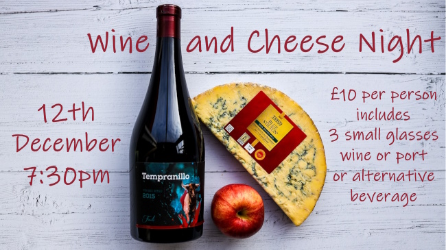 An unopened bottle of Italian red and a large half circle of blue cheese arranged with a red apple promotes the 12th December wine and cheese night.